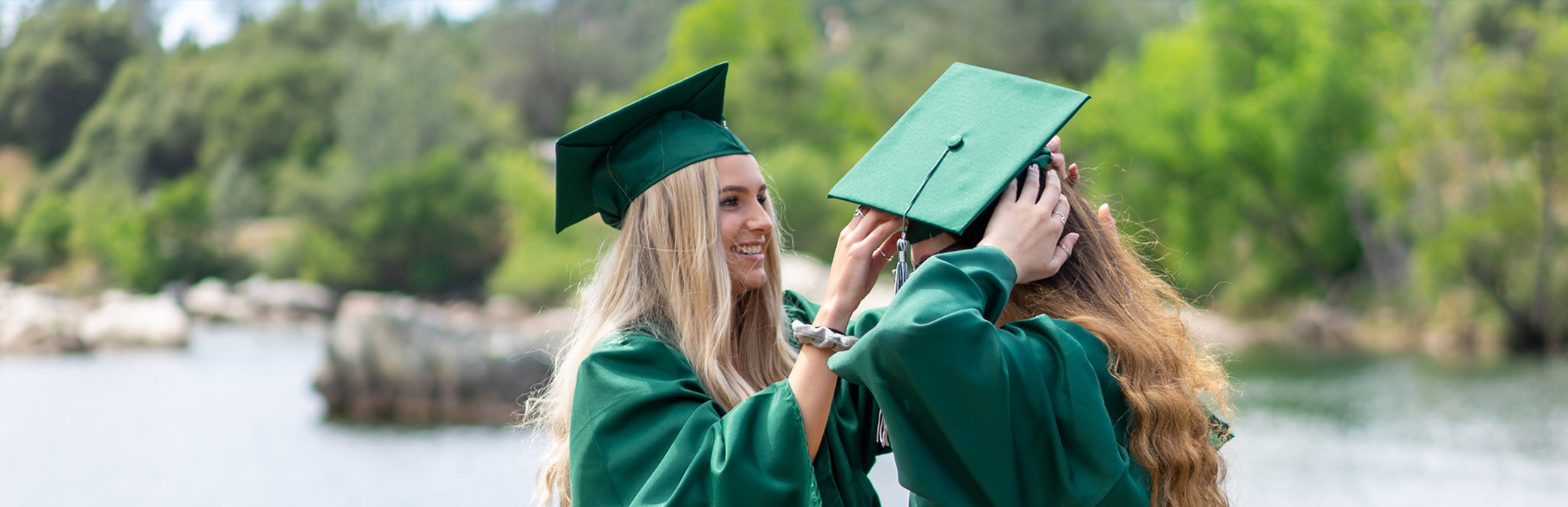 two women in graduation gowns and caps