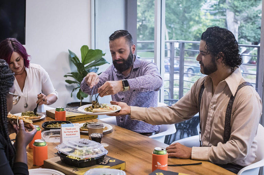 people enjoying a meal around a table